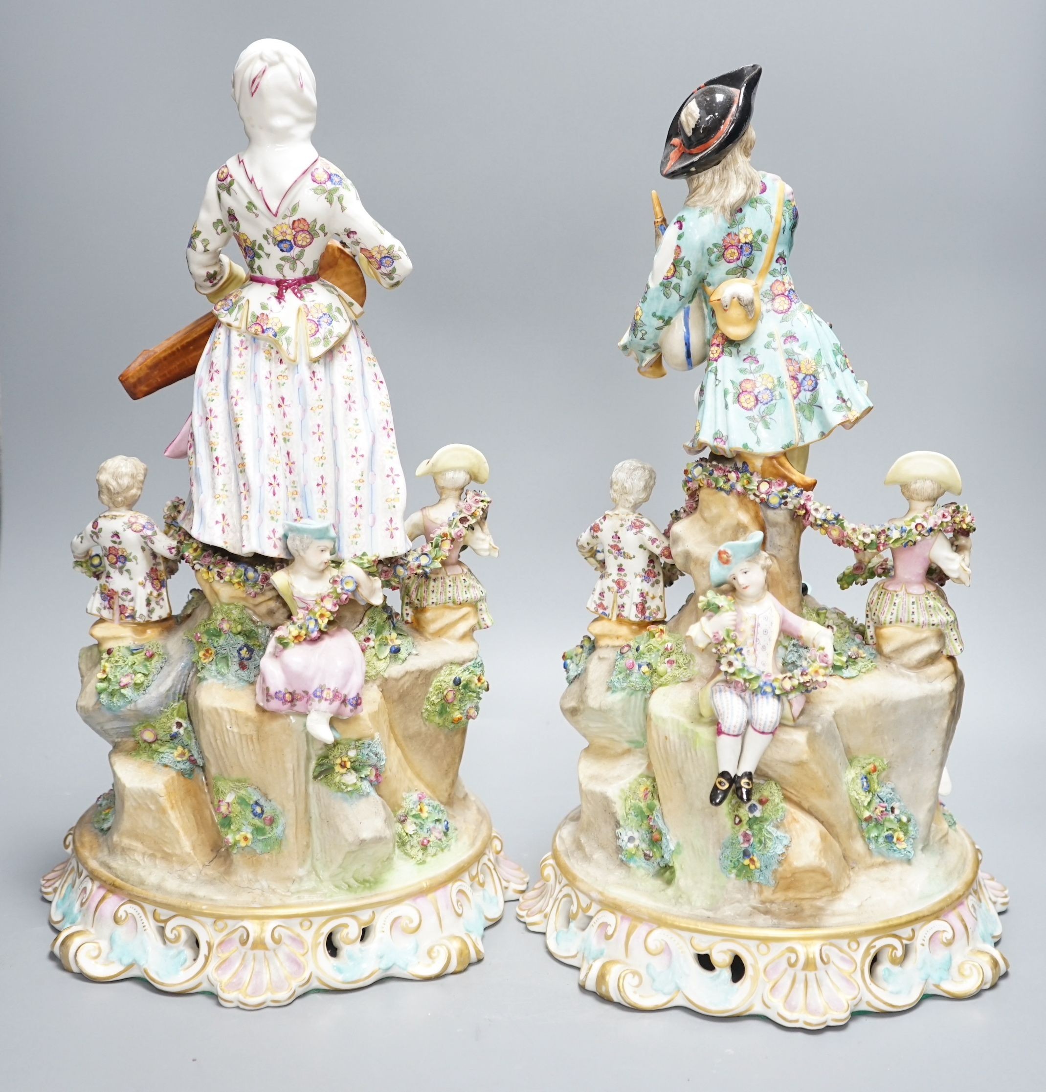 A pair of Meissen style porcelain musician figure groups, 42cms high